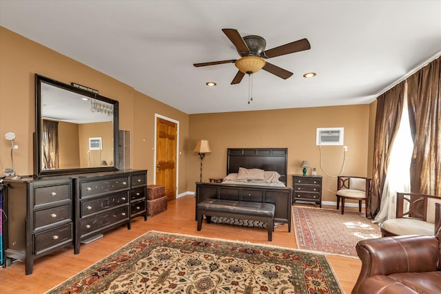 580 Foxhurst Rd, Baldwin, NY 11510 - bedroom with a wall unit AC, wood finished floors, baseboards, recessed lighting, and a ceiling fan