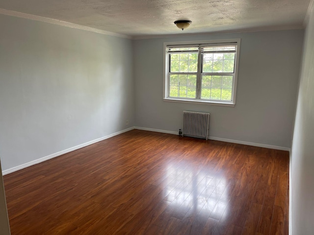 78-05 Park Dr E Unit 4B, Kew Garden Hills, NY 11367 - spare room featuring radiator heating unit, ornamental molding, dark wood-style floors, and a textured ceiling