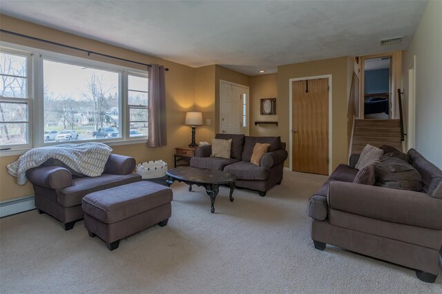 living area with stairs, visible vents, carpet floors, and baseboard heating