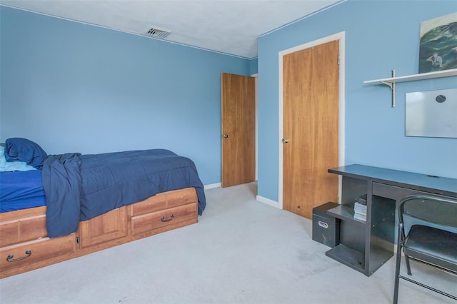 bedroom with baseboards, visible vents, and carpet