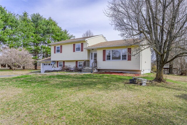 split level home featuring a front yard and an attached garage