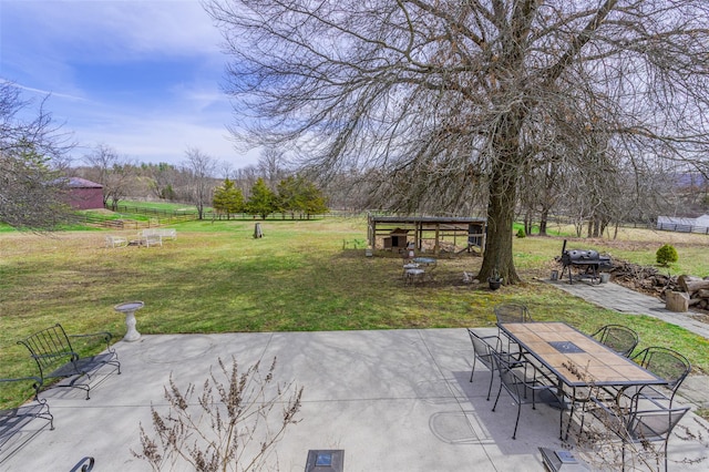 view of patio / terrace featuring outdoor dining area, an outbuilding, and fence