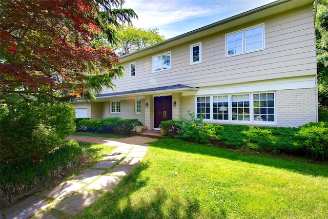 65 Elm Dr, East Hills, NY 11576 - view of front of house featuring a front yard and brick siding