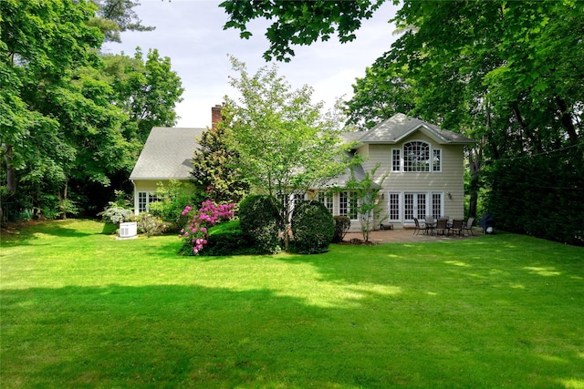 65 Elm Dr, East Hills, NY 11576 - back of house featuring a chimney, a patio, a yard, and french doors