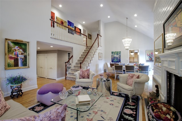 65 Elm Dr, East Hills, NY 11576 - living area with high vaulted ceiling, stairway, wood finished floors, a chandelier, and baseboards
