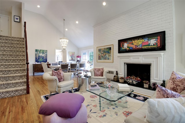 65 Elm Dr, East Hills, NY 11576 - living room featuring stairway, wood finished floors, recessed lighting, a fireplace, and high vaulted ceiling