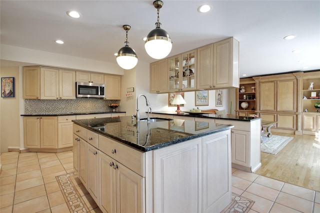65 Elm Dr, East Hills, NY 11576 - kitchen with stainless steel microwave, light tile patterned flooring, a sink, recessed lighting, and backsplash