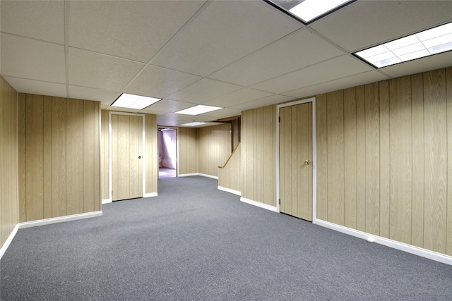 65 Elm Dr, East Hills, NY 11576 - finished below grade area featuring carpet flooring, a paneled ceiling, wooden walls, and baseboards