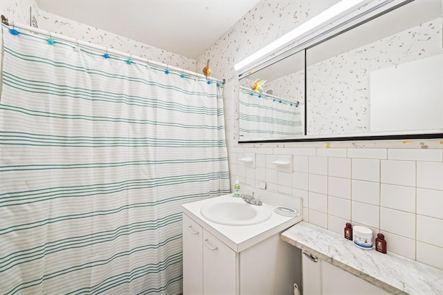 full bathroom with vanity, tile walls, wallpapered walls, and a shower with curtain