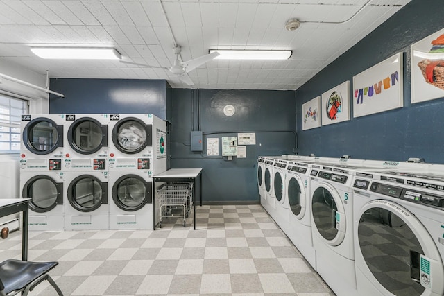 community laundry room featuring independent washer and dryer, stacked washer and clothes dryer, and light floors