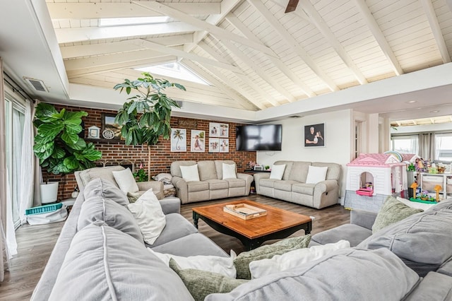 200 Block Ln, Island Park, NY 11558 - living room featuring brick wall, wood finished floors, beam ceiling, and high vaulted ceiling