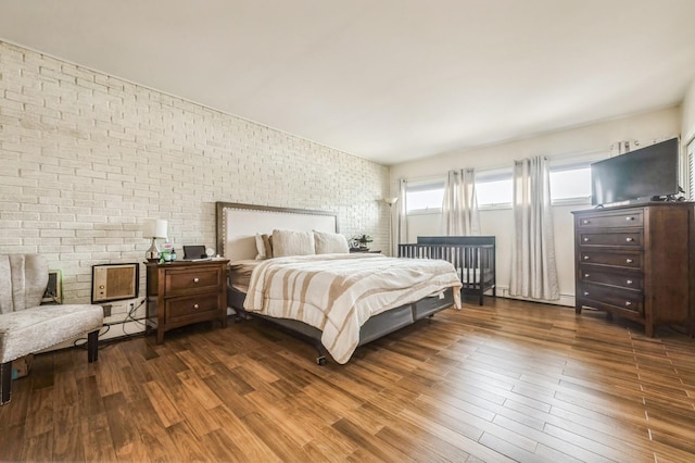 200 Block Ln, Island Park, NY 11558 - bedroom with brick wall and wood finished floors