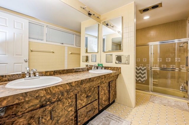 200 Block Ln, Island Park, NY 11558 - bathroom featuring tile walls, a shower stall, and double vanity