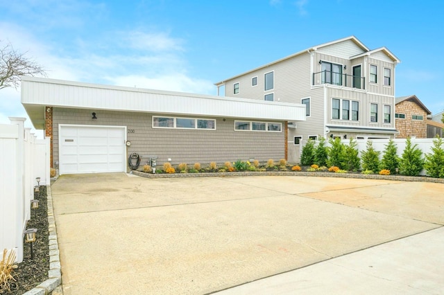 200 Block Ln, Island Park, NY 11558 - view of front facade with concrete driveway and a garage