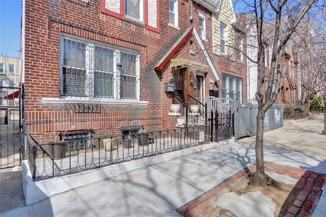 view of front facade with a fenced front yard and brick siding