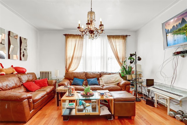 living room with radiator, hardwood / wood-style flooring, and a notable chandelier