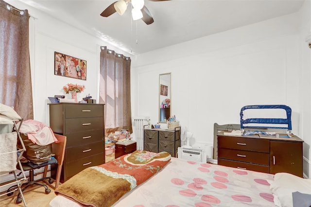 bedroom featuring ceiling fan and radiator