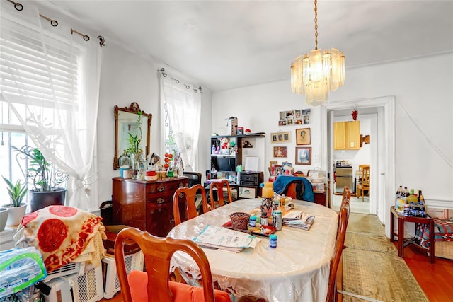 dining space featuring a notable chandelier and wood finished floors