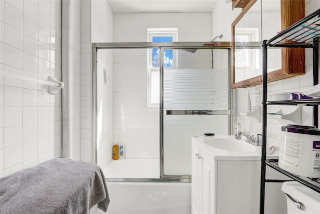 bathroom featuring enclosed tub / shower combo and vanity