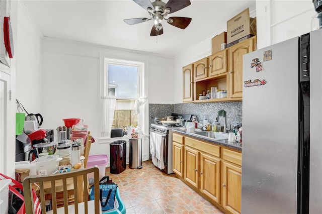 kitchen featuring a sink, a ceiling fan, tasteful backsplash, appliances with stainless steel finishes, and dark countertops