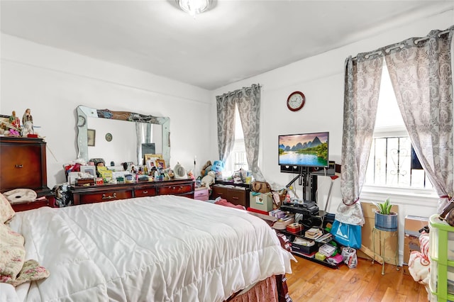 bedroom featuring hardwood / wood-style flooring and multiple windows