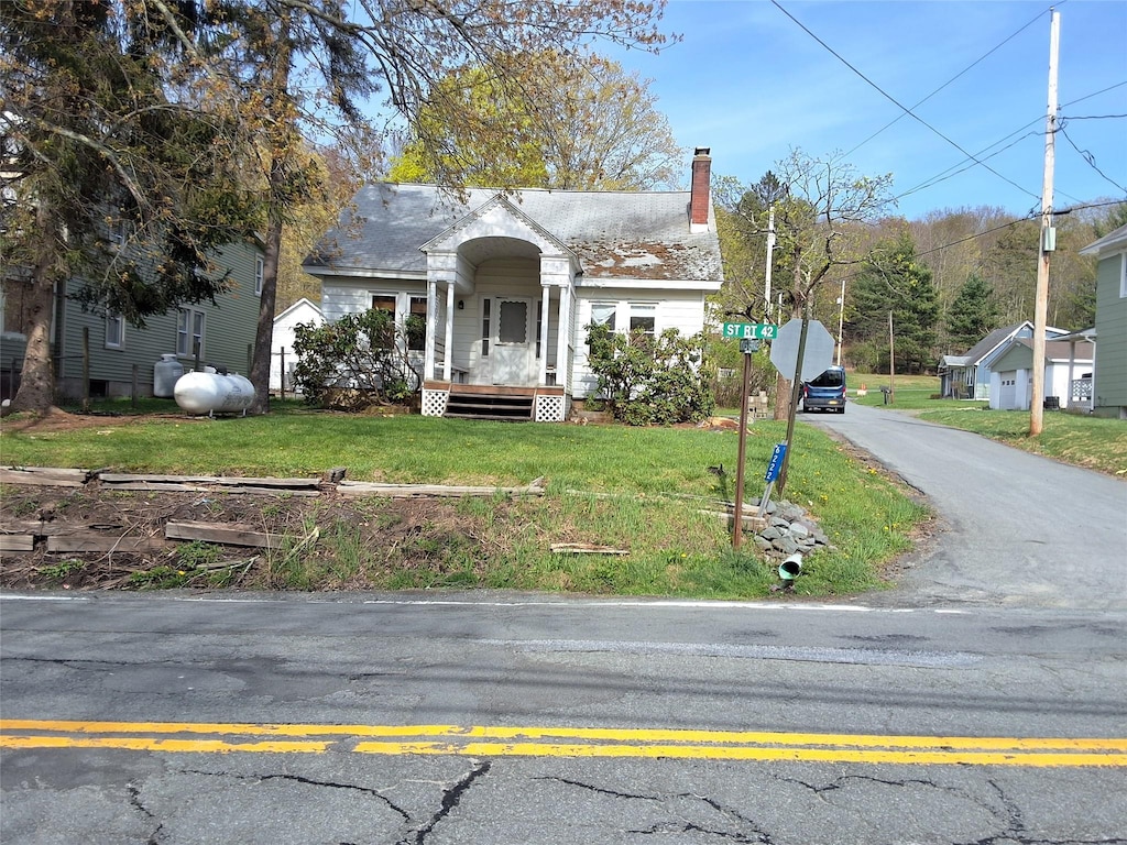 view of front of home with a front lawn and a chimney