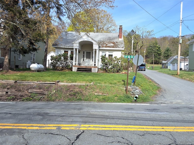 view of front of home with a front lawn and a chimney