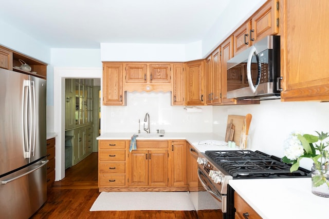 27 Powder Mill Rd, Newburgh, NY 12550 - kitchen with appliances with stainless steel finishes, a sink, dark wood-style floors, light countertops, and brown cabinetry
