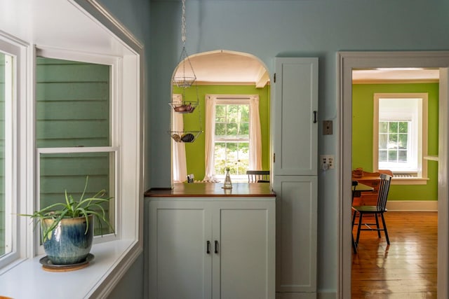 27 Powder Mill Rd, Newburgh, NY 12550 - bar area featuring arched walkways, wood-type flooring, and baseboards