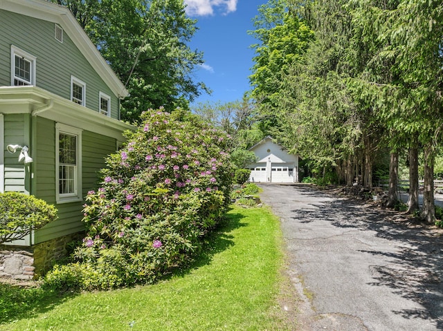 27 Powder Mill Rd, Newburgh, NY 12550 - view of side of property featuring a detached garage and an outdoor structure