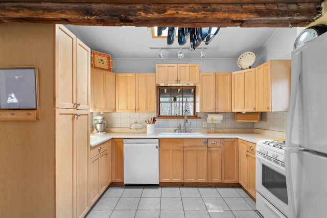 kitchen with light brown cabinets, a sink, white appliances, and light countertops
