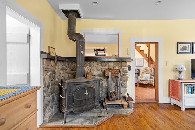 room details featuring a wood stove and wood finished floors