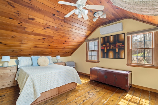 bedroom with wood-type flooring, baseboards, and a wall unit AC