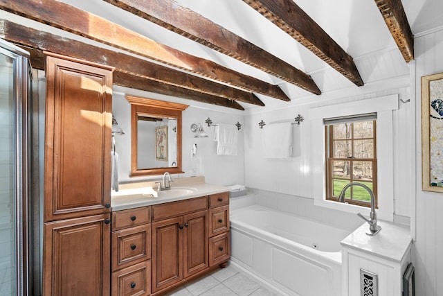 bathroom featuring tile patterned floors, vanity, beam ceiling, and a tub with jets