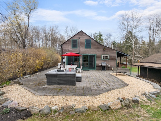 rear view of house featuring an outdoor hangout area and a patio