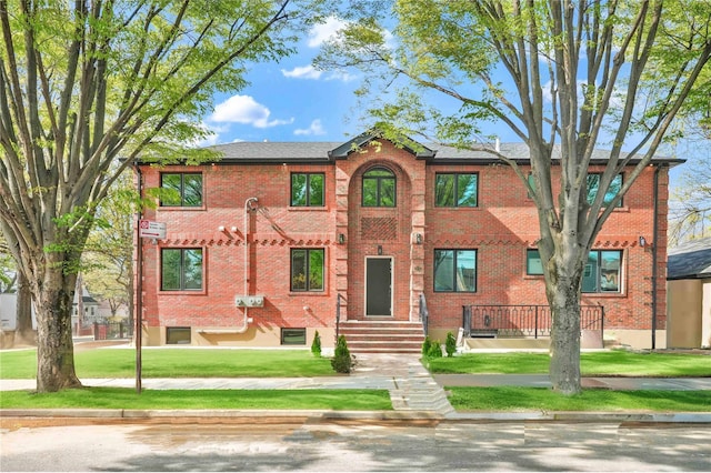 76-17 162nd St, Fresh Meadows, NY 11366 - view of front facade with brick siding and a front yard