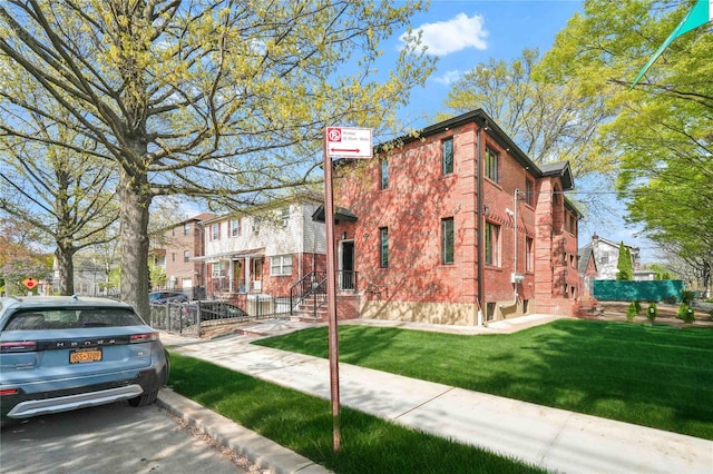 76-17 162nd St, Fresh Meadows, NY 11366 - exterior space with a yard, brick siding, and fence