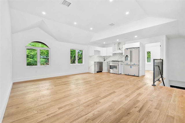 76-17 162nd St, Fresh Meadows, NY 11366 - unfurnished living room featuring a healthy amount of sunlight, light wood-style floors, recessed lighting, and visible vents