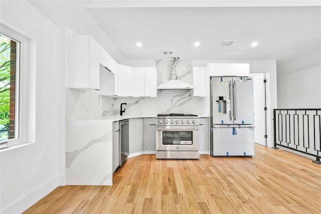 76-17 162nd St, Fresh Meadows, NY 11366 - kitchen featuring stainless steel appliances, white cabinetry, modern cabinets, and wall chimney exhaust hood