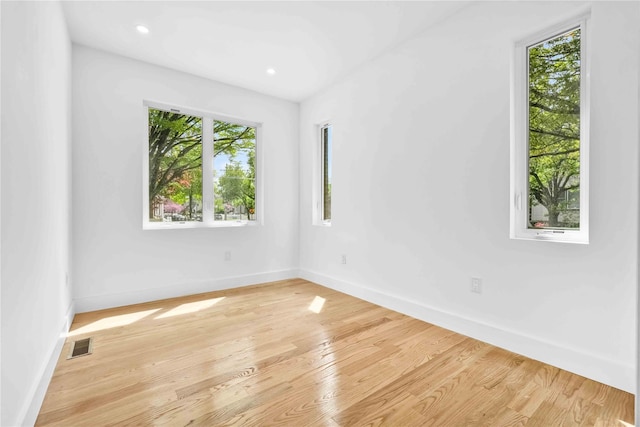 76-17 162nd St, Fresh Meadows, NY 11366 - unfurnished room with baseboards, plenty of natural light, light wood-style flooring, and visible vents
