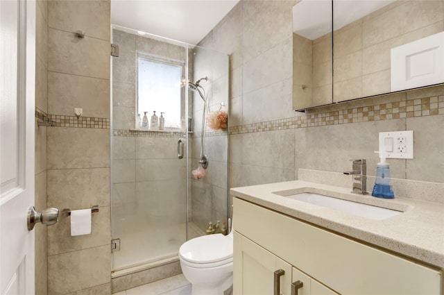 full bath with tile walls, toilet, a stall shower, and vanity
