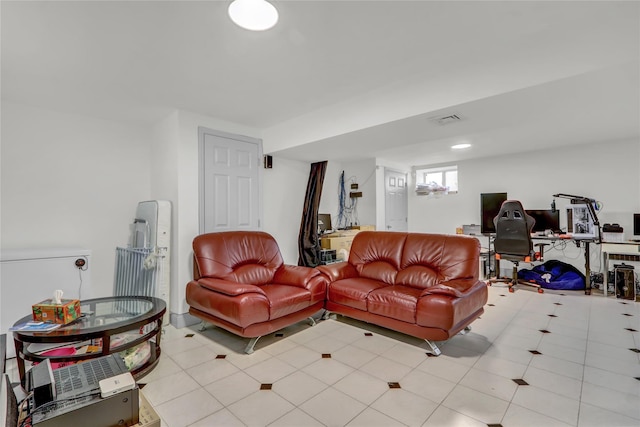 living room featuring light tile patterned floors and visible vents