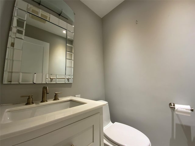 half bathroom featuring toilet and vanity