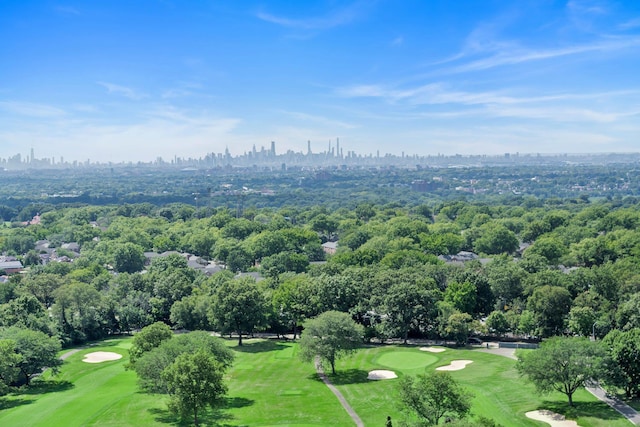 aerial view of a skyline view, a golf club, and a tree filled landscape