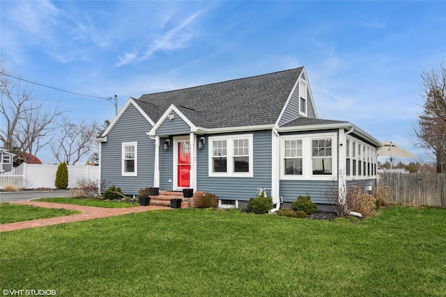 4100 Youngs Ave, Southold, NY 11971 - view of front of house featuring a front lawn, roof with shingles, and fence
