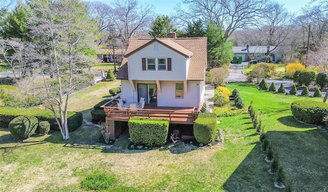 675 N Oakwood Rd, Laurel, NY 11948 - rear view of house featuring a yard, a chimney, and a deck