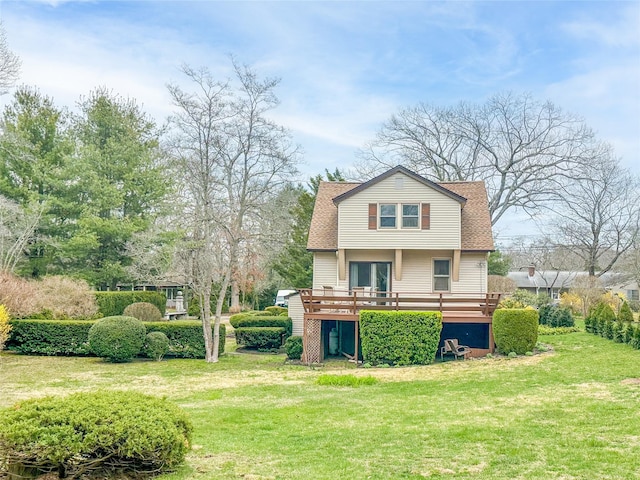 675 N Oakwood Rd, Laurel, NY 11948 - back of house with a yard, roof with shingles, and a deck