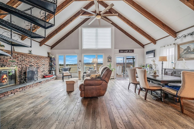 19 Hillside Ave, Northport, NY 11768 - living room featuring high vaulted ceiling, hardwood / wood-style floors, ceiling fan, a brick fireplace, and beam ceiling