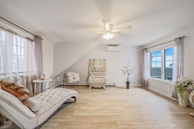 19 Hillside Ave, Northport, NY 11768 - living area featuring a wall unit AC, light wood-type flooring, a ceiling fan, and baseboards