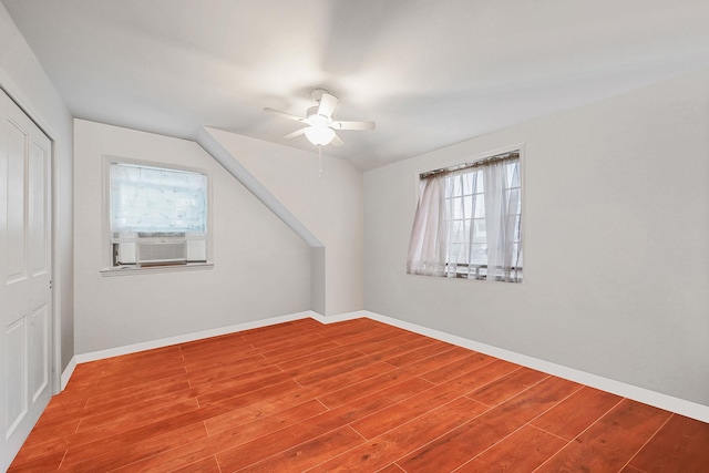 19 Hillside Ave, Northport, NY 11768 - additional living space featuring plenty of natural light, ceiling fan, wood finished floors, baseboards, and vaulted ceiling